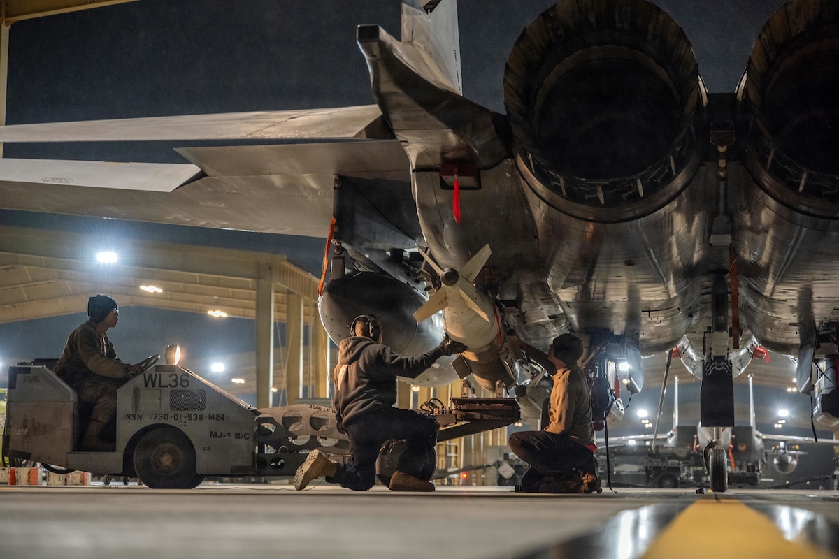 Airmen loading bombs onto F-15