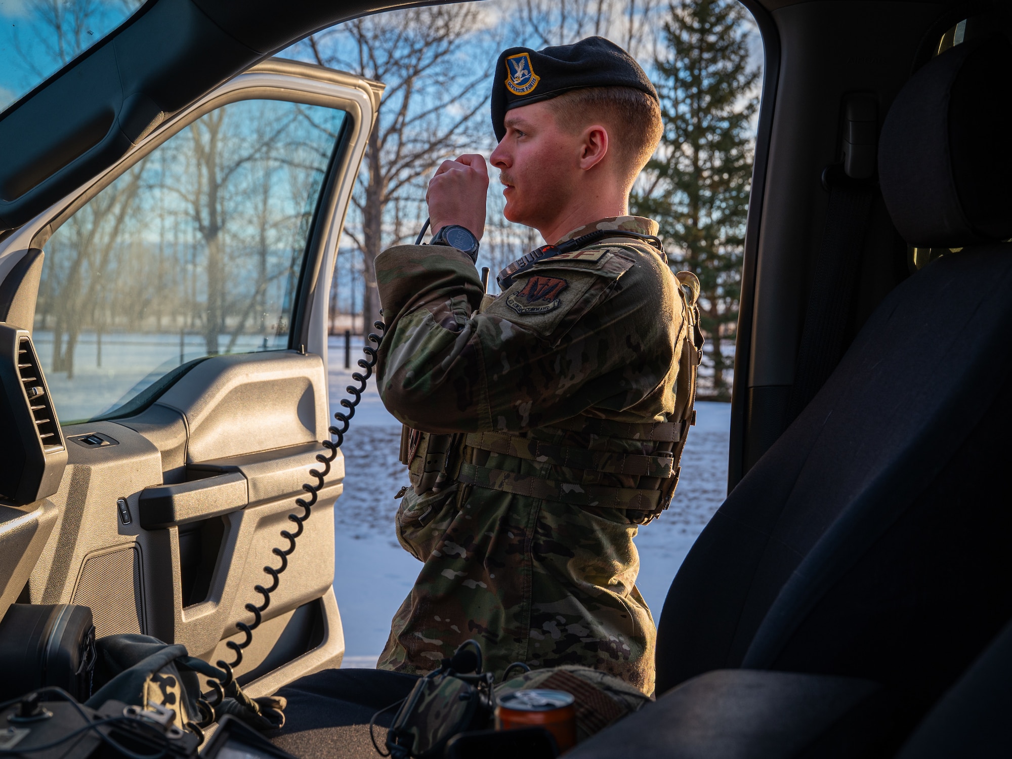 A photo of a military member holding an intercom.