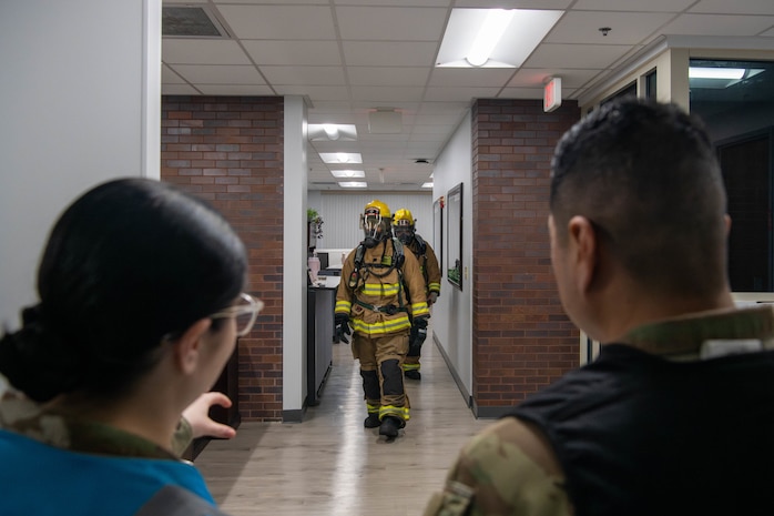 A photo of two service members inspecting the Civil Engineering Squadron