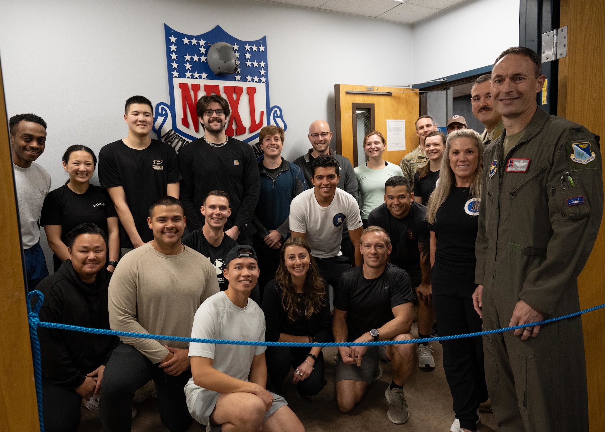 Airmen,  Comprehensive Readiness For Aircrew Flying Training (CRAFT) staff, and leadership pose for a group photo during the opening of the new Tactical Athlete Center (TAC) at Laughlin Air Force Base, Texas, Jan. 12, 2025. The TAC supports aircrew readiness through integrated strength and conditioning, injury prevention, and human performance training tailored to mission demands. (Air Force photo by Airman 1st Class Harrison Sullivan)