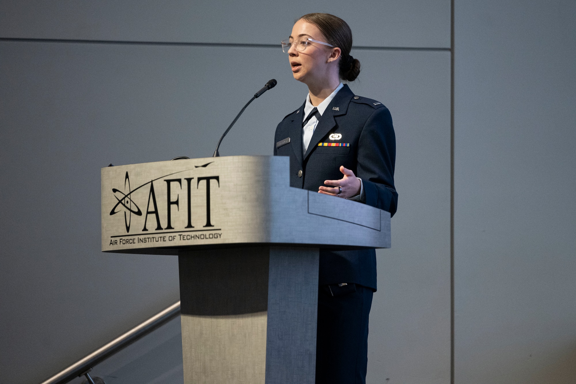 1st Lt. Adrianna Blenkush stands at a podium speaking at a conference.