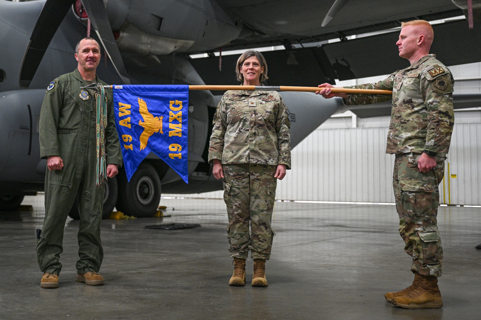 U.S. Air Force Airmen assigned to the 19th Airlift Wing unveil the 19th Maintenance Group guidon during a reactivation ceremony, Jan. 23, 2026, at Little Rock Air Force Base, Arkansas. As one of the Air Force’s first Units of Action, the 19th AW continues to play a key role in shaping how wings organize, train, and deploy to meet future operational demands.