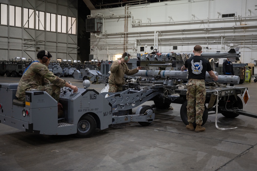 U.S. Air Force Airman 1st Class Jordyn Heard, left, 355th Fighter Generation Squadron load crew member, Staff Sgt. Tyler Kelly, center, 355th FGS load crew chief, and Airman 1st Class Kurt Reichert, right, 355th FGS load crew member, compete in the 2026 Annual Load Competition at Eielson Air Force Base, Alaska, Jan. 23, 2026.