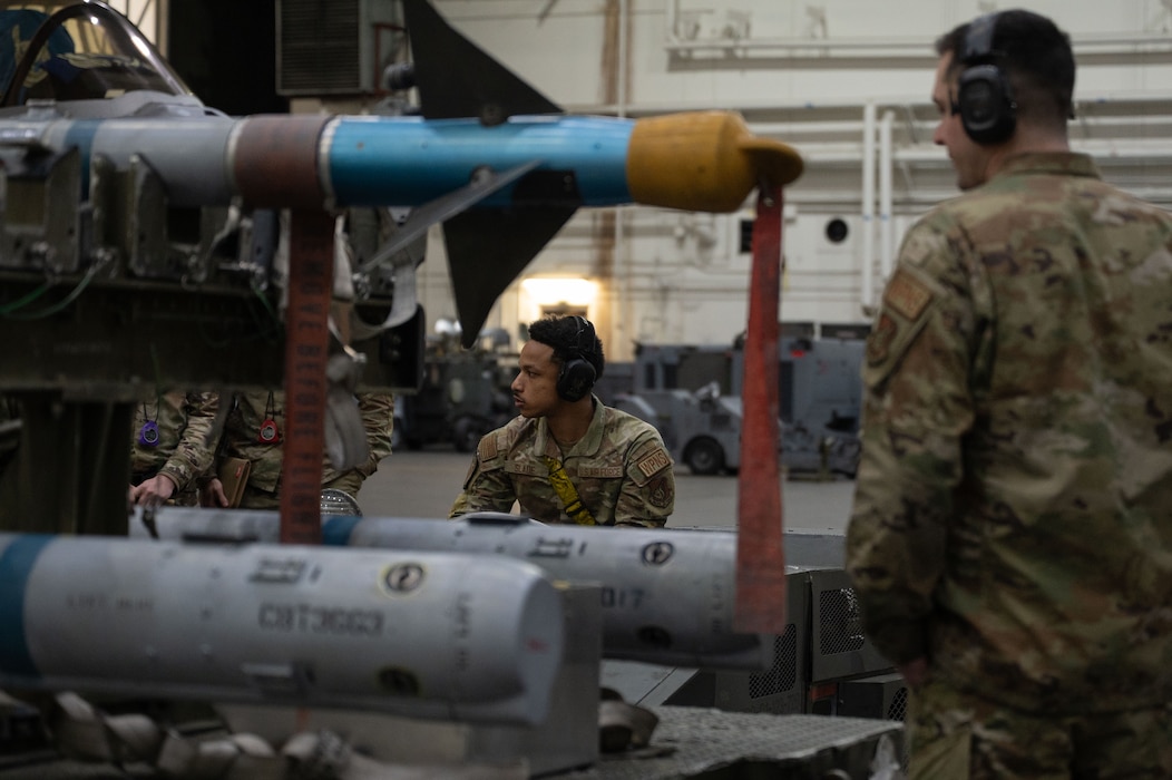 U.S. Air Force Senior Airman Christian Slade, center, 18th Fighter Generation Squadron load crew member, competes in the 2026 Annual Load Competition at Eielson Air Force Base, Alaska, Jan. 23, 2026.