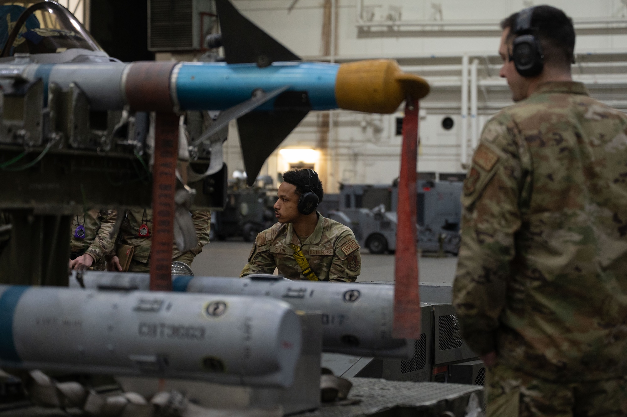 U.S. Air Force Senior Airman Christian Slade, center, 18th Fighter Generation Squadron load crew member, competes in the 2026 Annual Load Competition at Eielson Air Force Base, Alaska, Jan. 23, 2026.