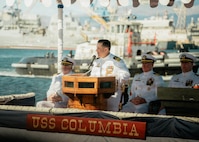 JOINT BASE PEARL HARBOR-HICKAM, Hawaii (Nov. 18, 2025) - Cmdr. Brad Foster, outgoing commanding officer of Los Angeles-class fast-attack submarine USS Columbia (SSN 771), gives remarks during the change of command ceremony for Columbia at Joint Base Pearl Harbor-Hickam, Hawaii, Nov. 18, 2025. Columbia is assigned to Submarine Squadron 7 and is capable of supporting various missions, including anti-submarine warfare, anti-surface ship warfare, strike warfare, special operations forces support, and intelligence, surveillance, and reconnaissance. (U.S. Navy photo by Mass Communication Specialist 2nd Class Nicholas Russell)