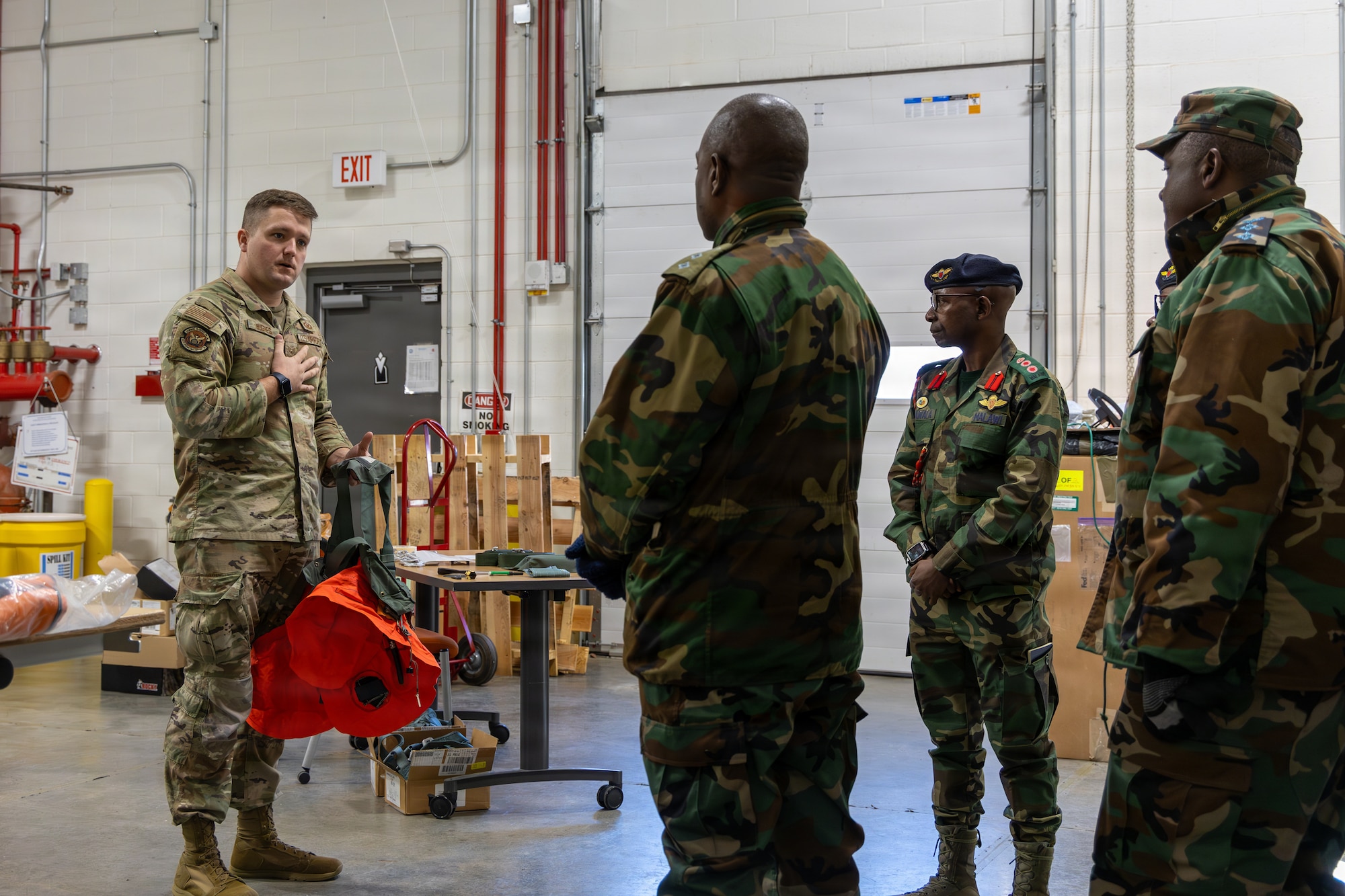 U.S. Air Force Staff Sgt. Cory M. Hughes, 145th Operational Support Squadron, aircrew flight equipment technician, demonstrates the use of a flotation device to the members of the Malawian and Zambian air forces at the Charlotte Air National Guard Base, Charlotte, N.C., Jan. 15, 2026.