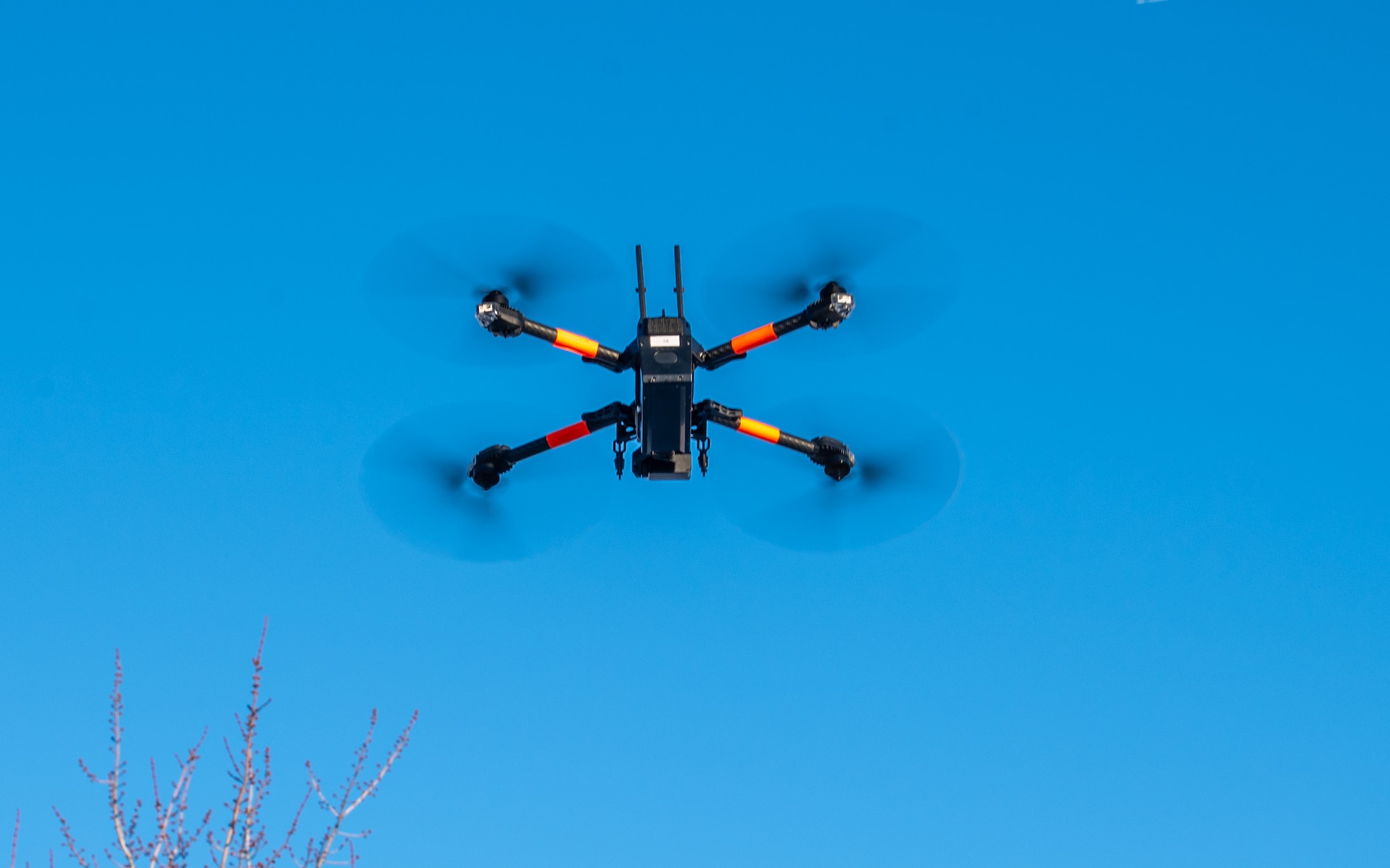 A photo of a small- unmanned aircraft hovering in the air.