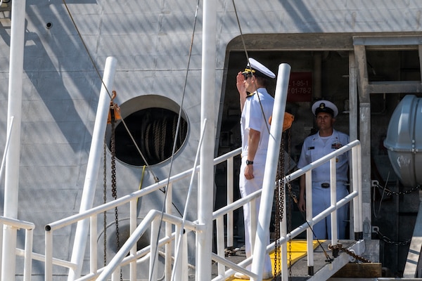Cmdr. Andrew Recame, commanding officer of Independence-Variant littoral combat ship USS Cincinnati (LCS 20) salutes the ensign before disembarking Cincinnati at Ream Naval Base, Cambodia, Jan. 24.