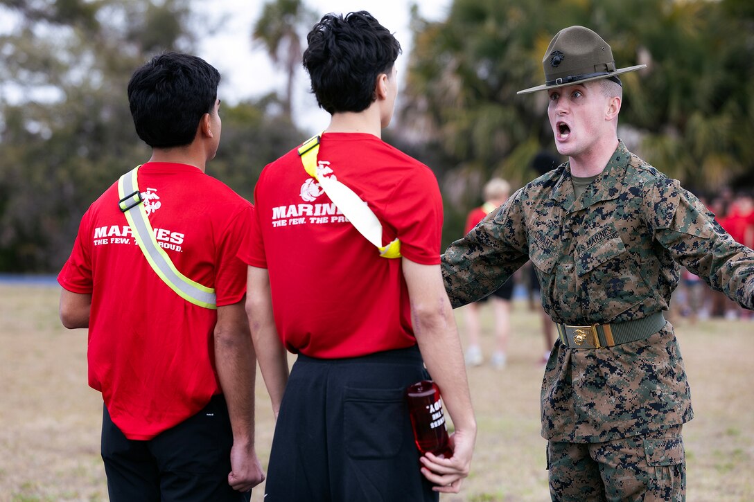 U.S. Marine Corps Sgt. Deacon Cowart, a drill instructor from Marine Corps Recruit Depot Parris Island, gives orders during a poolee function Jan. 24, 2026, at Marine Corps Support Facility Blount Island, Florida. The event, hosted by Marine Corps Recruiting Station Jacksonville and supported by drill instructors from Marine Corps Recruit Depot Parris Island in South Carolina, tested the physical and mental readiness of future Marines as part of their preparation for recruit training. (Official Marine Corps photo by Dustin Senger)