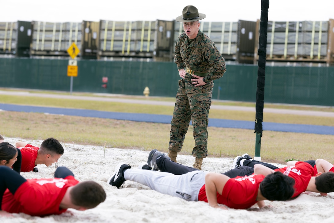 U.S. Marine Corps Sgt. John Lawson, a drill instructor from Marine Corps Recruit Depot Parris Island, gives orders during a poolee function Jan. 24, 2026, at Marine Corps Support Facility Blount Island, Florida. The event, hosted by Marine Corps Recruiting Station Jacksonville and supported by drill instructors from Marine Corps Recruit Depot Parris Island in South Carolina, tested the physical and mental readiness of future Marines as part of their preparation for recruit training. (Official Marine Corps photo by Dustin Senger)
