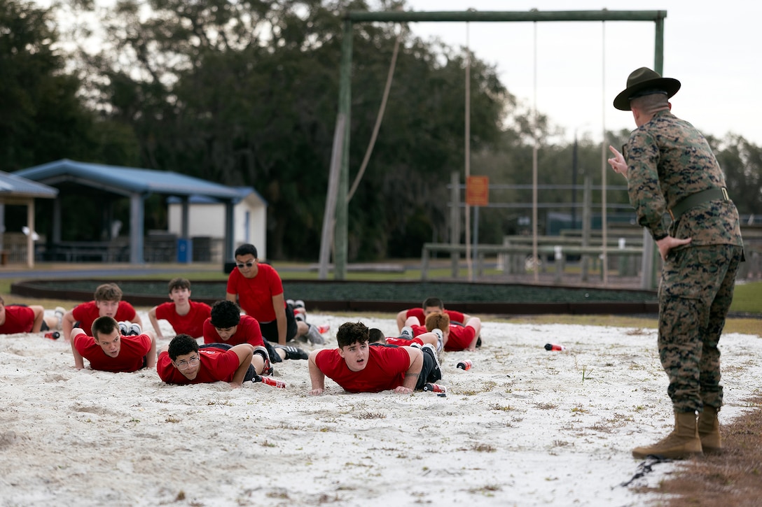 U.S. Marine Corps Sgt. John Lawson, a drill instructor from Marine Corps Recruit Depot Parris Island, gives orders during a poolee function Jan. 24, 2026, at Marine Corps Support Facility Blount Island, Florida. The event, hosted by Marine Corps Recruiting Station Jacksonville and supported by drill instructors from Marine Corps Recruit Depot Parris Island in South Carolina, tested the physical and mental readiness of future Marines as part of their preparation for recruit training. (Official Marine Corps photo by Dustin Senger)