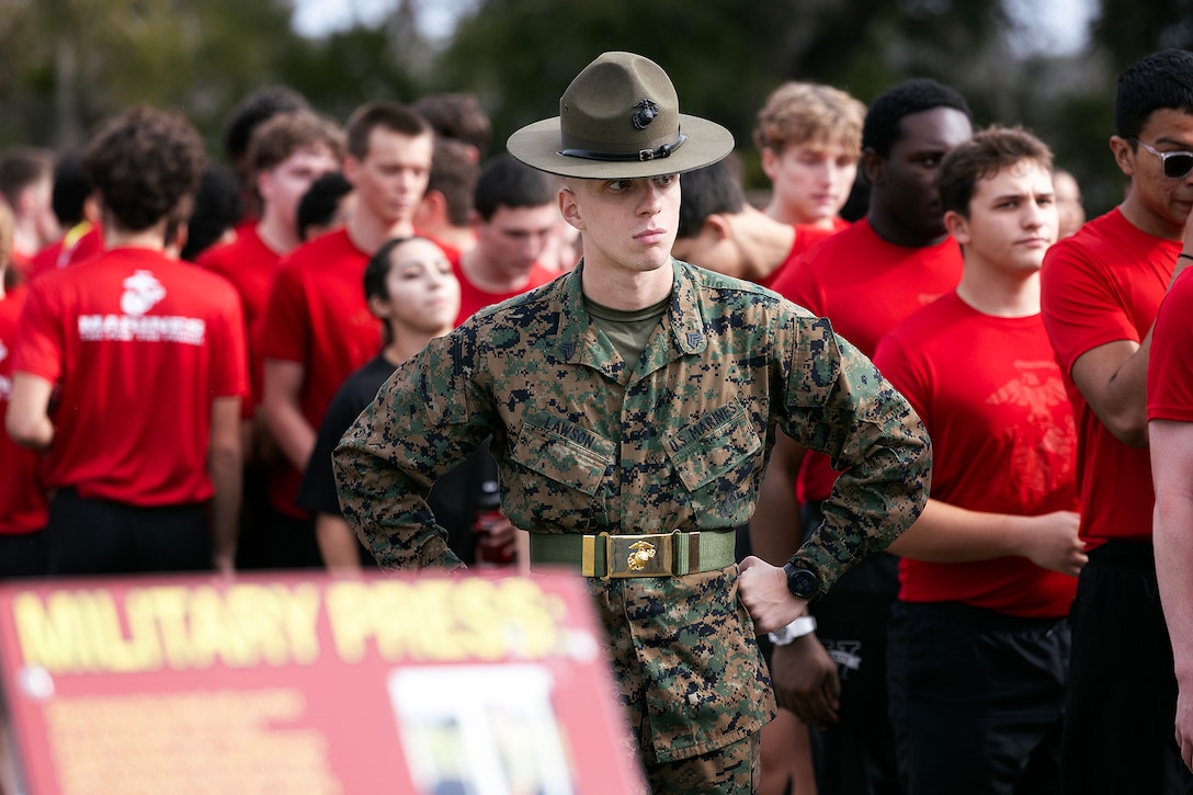 U.S. Marine Corps Sgt. John Lawson, a drill instructor from Marine Corps Recruit Depot Parris Island, prepares for a pull-up challenge during a poolee function Jan. 24, 2026, at Marine Corps Support Facility Blount Island, Florida. The event, hosted by Marine Corps Recruiting Station Jacksonville and supported by drill instructors from Marine Corps Recruit Depot Parris Island in South Carolina, tested the physical and mental readiness of future Marines as part of their preparation for recruit training. (Official Marine Corps photo by Dustin Senger)