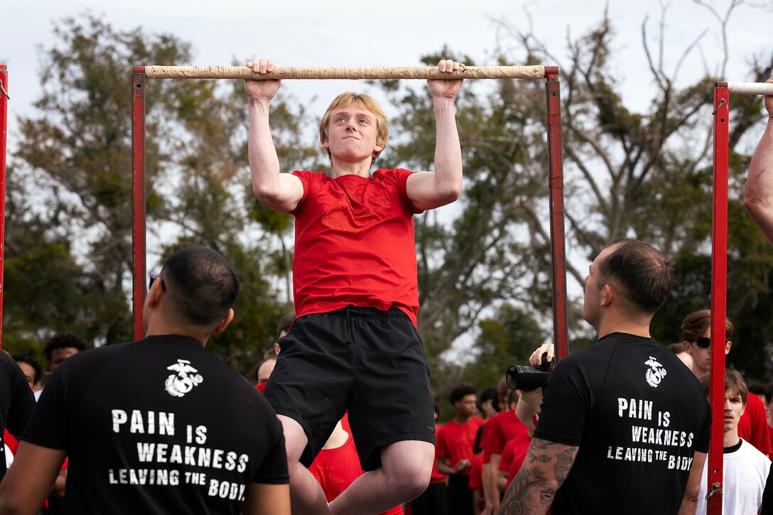 Young men and women from across Georgia and Florida complete a pull-up challenge during a poolee function Jan. 24 at Marine Corps Support Facility Blount Island, Florida. The event, hosted by Marine Corps Recruiting Station Jacksonville and supported by drill instructors from Marine Corps Recruit Depot Parris Island in South Carolina, tested the physical and mental readiness of future Marines as part of their preparation for recruit training. (Official Marine Corps photo by Dustin Senger)