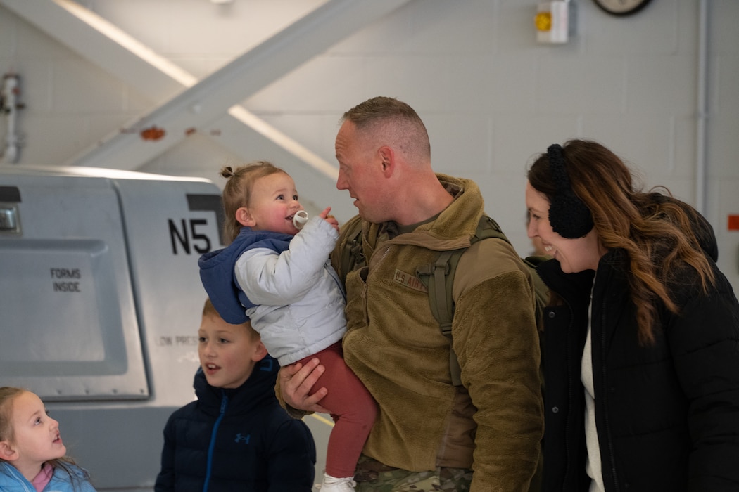 Master Sgt. Tanner Pry holds his hugs and holds his daughter as he is greeted by his family.