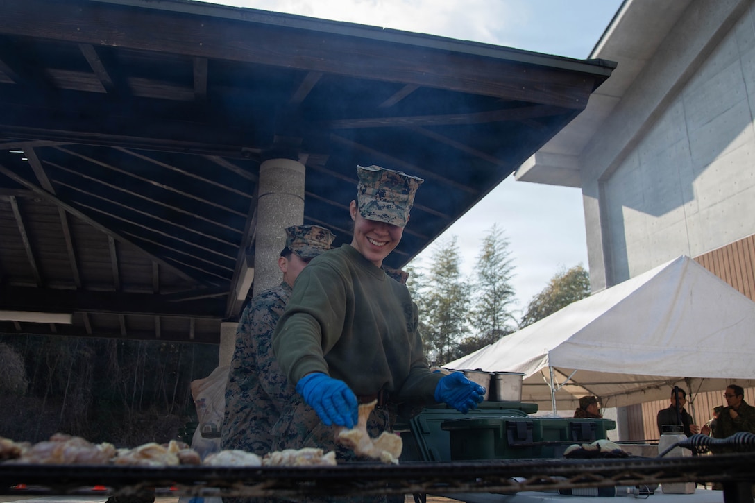 U.S. Marine Corps Cpl. Amanda Morenaokaun, a food service specialist with Headquarters and Headquarters Squadron, Marine Corps Air Station Iwakuni, and a native of Cuba, grills chicken in a field kitchen during exercise Nankai Rescue 2026 at the Lotus Cultural Center, Iwakuni, Japan, Jan. 24, 2026. Exercise Nankai Rescue 2026 is a full-scale exercise focused on enhancing the bilateral coordination between the U.S. and Japan in support of humanitarian and disaster relief efforts. (U.S. Marine Corps photo by Lance Cpl. Tyler Bassett)