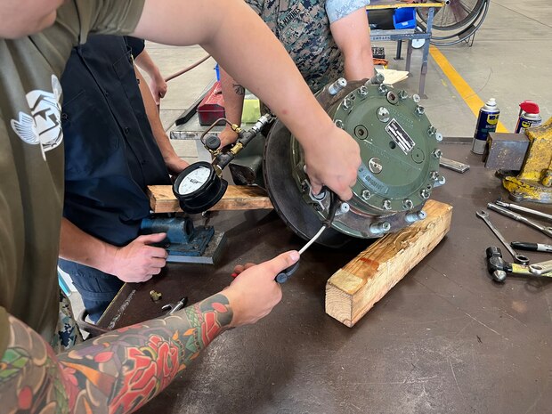 Marines with the General Support Maintenance Platoon, Intermediate Repair Company, 3d Maintenance Battalion, 3d Marine Logistics Group, conduct work on an Amphibious Combat Vehicle wheel end assembly at Camp Kinser, Okinawa, Japan, Nov. 13, 2025. Marines with the GSM Platoon, in concert with 3d Maint. Bn’s Manufacturing Platoon, has been building their ACV secondary repairable capabilities beyond the traditional scope of an intermediate-level repair facility, out-pacing Marine Corps Logistics Command to support the overall readiness of III Marine Expeditionary Force’s ACV units. (U.S. Marine Corps photo by Gunnery Sgt. Jonathan Wright)