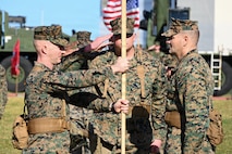 U.S. Marine Corps Lt. Col. David Janecke, right, outgoing commanding officer of 3rd Maintenance Battalion, 3rd Marine Logistics Group, passes the unit colors to Lt. Col. John Sykas III, the incoming commanding officer of 3rd Maintenance Battalion, 3rd MLG, during a change of command ceremony at Camp Kinser, Okinawa, Japan, Jan. 16, 2026. Lt. Col. David Janecke relinquished command of 3rd Maintenance Battalion to Lt. Col. John Sykas III. (U.S. Marine Corps photo by Lance Cpl. Rachel Mason)