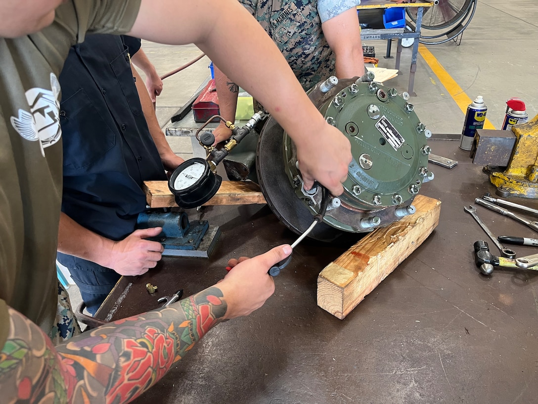 Marines with the General Support Maintenance Platoon, Intermediate Repair Company, 3d Maintenance Battalion, 3d Marine Logistics Group, conduct work on an Amphibious Combat Vehicle wheel end assembly at Camp Kinser, Okinawa, Japan, Nov. 13, 2025. Marines with the GSM Platoon, in concert with 3d Maint. Bn’s Manufacturing Platoon, has been building their ACV secondary repairable capabilities beyond the traditional scope of an intermediate-level repair facility, out-pacing Marine Corps Logistics Command to support the overall readiness of III Marine Expeditionary Force’s ACV units. (U.S. Marine Corps photo by Gunnery Sgt. Jonathan Wright)