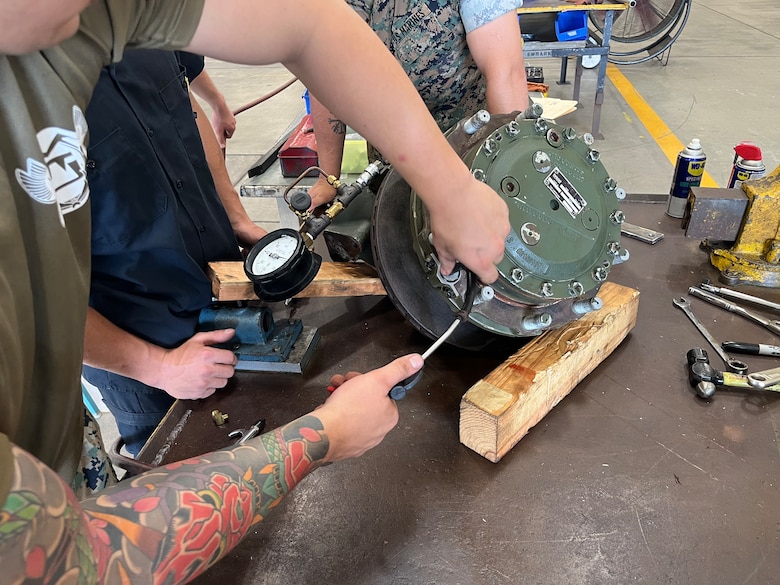 Marines with the General Support Maintenance Platoon, Intermediate Repair Company, 3d Maintenance Battalion, 3d Marine Logistics Group, conduct work on an Amphibious Combat Vehicle wheel end assembly at Camp Kinser, Okinawa, Japan, Nov. 13, 2025. Marines with the GSM Platoon, in concert with 3d Maint. Bn’s Manufacturing Platoon, has been building their ACV secondary repairable capabilities beyond the traditional scope of an intermediate-level repair facility, out-pacing Marine Corps Logistics Command to support the overall readiness of III Marine Expeditionary Force’s ACV units. (U.S. Marine Corps photo by Gunnery Sgt. Jonathan Wright)