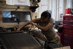 U.S. Army Sgt. Gelensia Jackson, a wheeled vehicle mechanic with the Washington-based Field Maintenance Shop (FMS), Joint Force Headquarters, Georgia Army National Guard, makes repairs on a Humvee in Augusta, Georgia, Oct. 2, 2024. The Georgia National Guard has mobilized to provide response and recovery support to areas in the state impacted by Hurricane Helene. At the direction of the Governor and through the Georgia Emergency Management and Homeland Security Agency (GEMA/HS), the Georgia National Guard will continue to partner local, state, and federal entities in this effort. (U.S. National Guard Photo by Sgt. Thomas Norris)