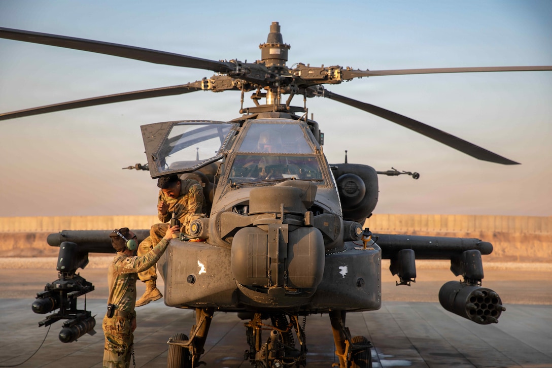 U.S. Army flight crewmembers assigned to Task Force Nighthawk, 6-17 Air Cavalry Squadron, 4th Combat Aviation Brigade, conduct flight checks on an AH-64 Apache attack helicopter prior to take-off in the U.S. Central Command Area of Responsibility on Nov. 5, 2025. Apache attack helicopters are primarily used for precision strikes, close air support, and air reconnaissance. (U.S. Army Photo by Capt. Bernard Jenkins Jr.)