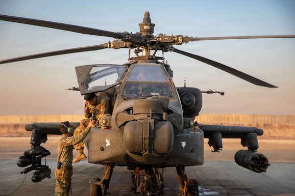 U.S. Army flight crewmembers assigned to Task Force Nighthawk, 6-17 Air Cavalry Squadron, 4th Combat Aviation Brigade, conduct flight checks on an AH-64 Apache attack helicopter prior to take-off in the U.S. Central Command Area of Responsibility on Nov. 5, 2025. Apache attack helicopters are primarily used for precision strikes, close air support, and air reconnaissance. (U.S. Army Photo by Capt. Bernard Jenkins Jr.)