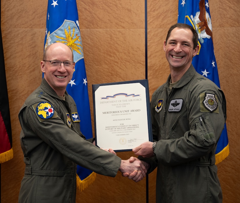 U.S. Air Force Lt. Gen. Jason T. Hinds, U.S. Air Forces in Europe – Air Forces Africa commander, presents the Meritorious Unit Award to Brig. Gen. Jack Arthaud, 48th Fighter Wing commander