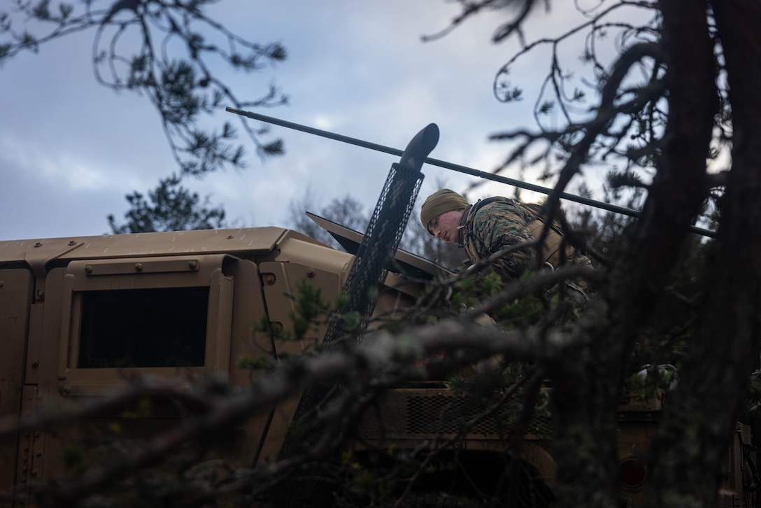 U.S. Marine Corps Cpl. Christian Haskell, a data systems administrator with Combat Logistics Battalion 6, Combat Logistics Regiment 2, 2nd Marine Logistics Group, plugs in a wire for a Star Shield communications system during Exercise Freezing Winds 2025 in Gylto, Finland, Dec. 1, 2025. The Cisco 1835 router works in tangent with the Star Shield communication system to provide internet capabilities for a variety of classification levels in an austere environment. Freezing Winds is conducted to increase interoperability between Marines, Finland, and NATO Allies by executing combined amphibious operations in and around the Baltic Sea littorals, and is part of a regularly occurring series of exercises in northern Europe that demonstrates the capability to deploy and train Marines and Sailors in support of the NATO Alliance. Haskell is a native of Texas. (U.S. Marine Corps photo by Lance Cpl. Brady V. Hathaway)