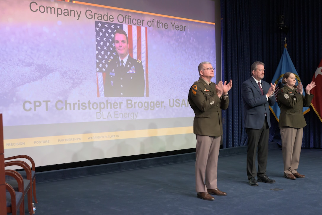 Individuals standing together on a stage.