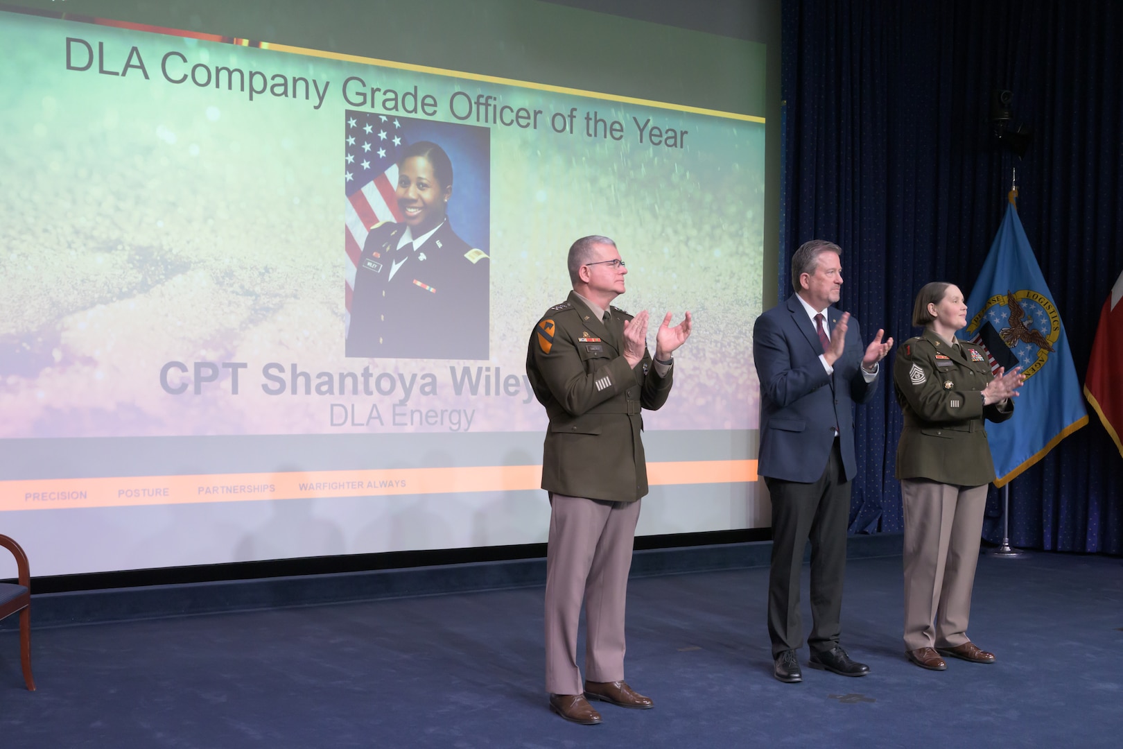 Individuals standing together on a stage.