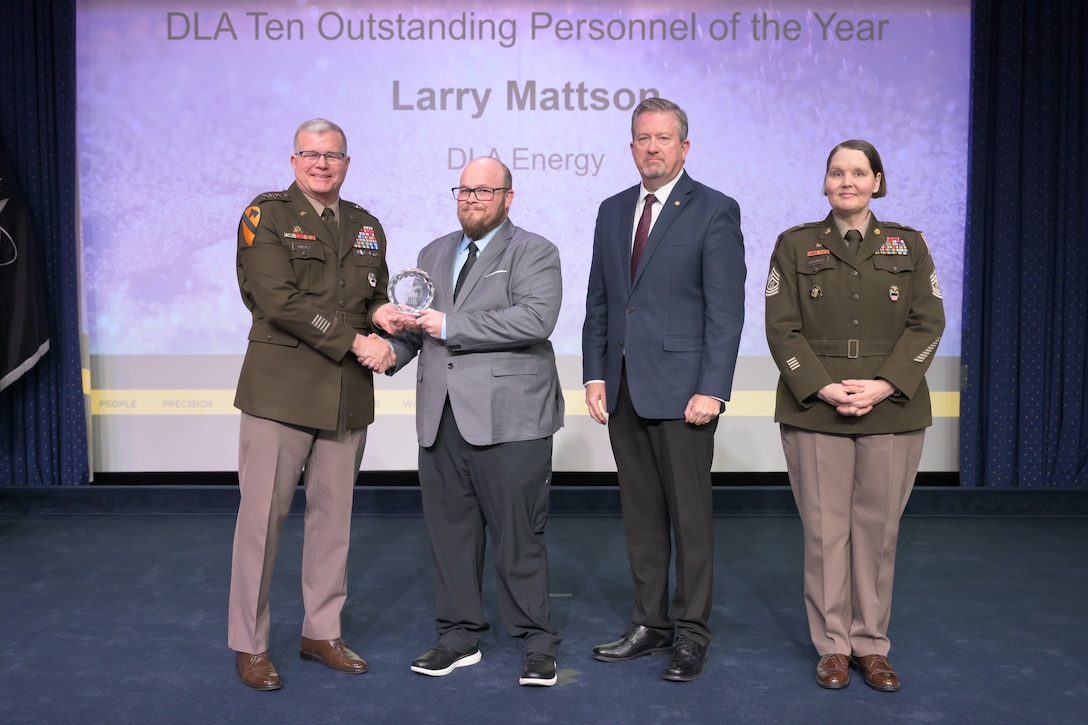 Individuals standing together on a stage.