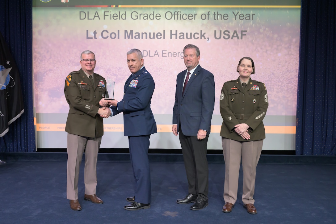 Individuals standing together on a stage.