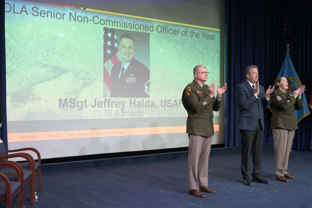 Individuals standing together on a stage.