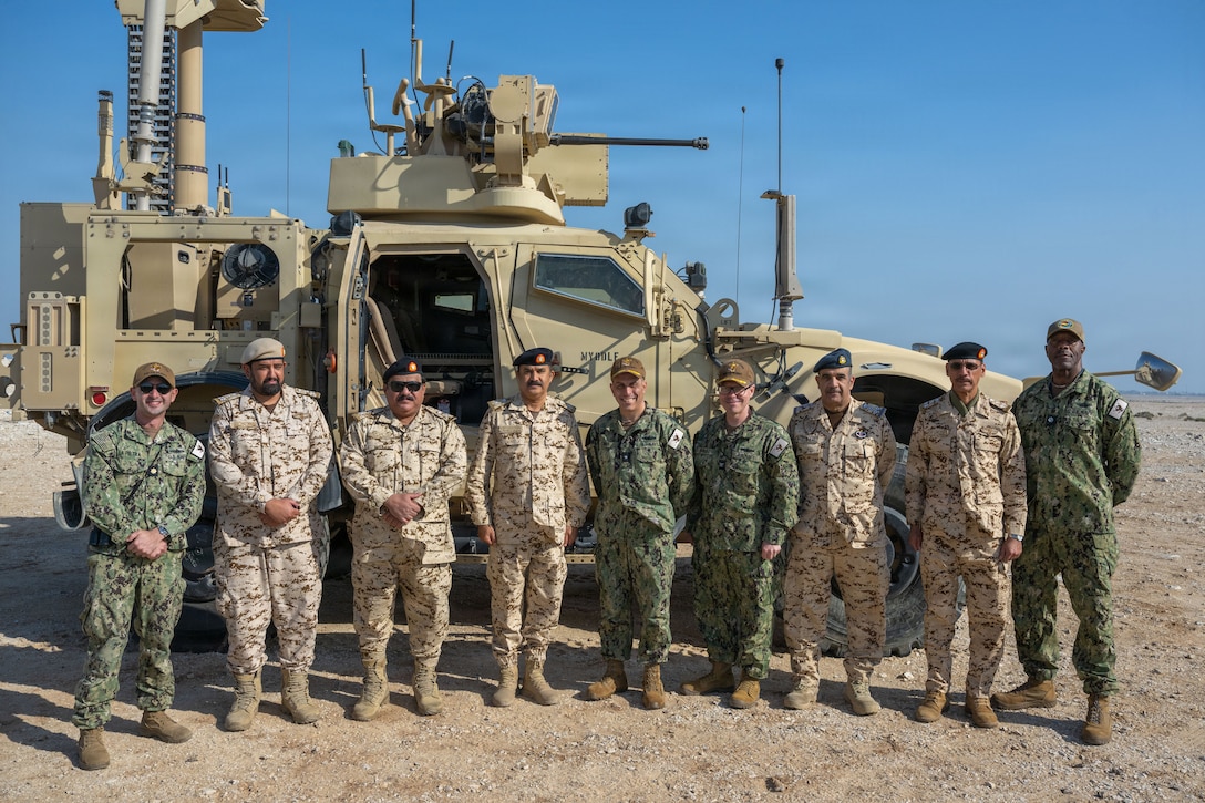 U.S. CENTRAL COMMAND AREA OF RESPONSIBILITY (Jan. 26, 2026) Personnel from the U.S. Navy and Bahrain Defense Force pose for a group photo after a mine-resistant ambush protected (MRAP) vehicle equipped with a mobile-low, slow, small-unmanned aircraft integrated defeat system (M-LIDS) launcher fires a counter-unmanned aerial system at a fixed wing target during a training exercise in Bahrain. This bilateral training between U.S. Naval Forces Central Command and the Bahrain Defense Force improves collaboration and interoperability between the U.S. and Bahrain. (U.S. Navy photo by Mass Communication Specialist 2nd Class Iain Page)