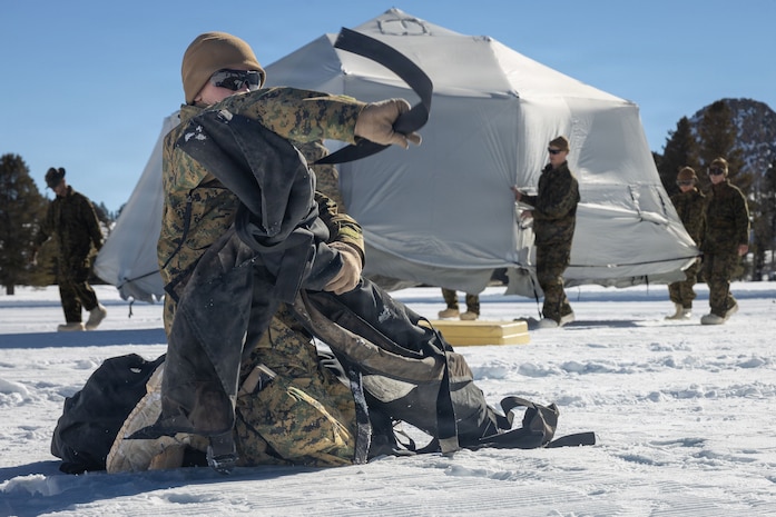 U.S. Marine Corps Lance Cpl. Hunter Bobholz, a logistics specialist with Combat Logistics Battalion 24, Combat Logistics Regiment 27, 2nd Marine Logistics Group, wraps up tent poles while establishing field lodging as part of Mountain Training Exercise 1-26 at Marine Corps Mountain Warfare Training Center in Bridgeport, California, Jan. 16, 2026. The field lodging will consist of a chapel, a forward battalion aid station, and a field Marine Corps Exchange to ensure the Marines and Sailors’ safety and quality of life throughout their time in the field. Exercises like MTX 1-26 prove Marines’ ability to provide flexible and responsive combat service support during high intensity combat operations in contested and mountainous terrain. Bobholz is a native of Wisconsin. (U.S. Marine Corps photo by Lance Cpl. Isabelle Veillette)