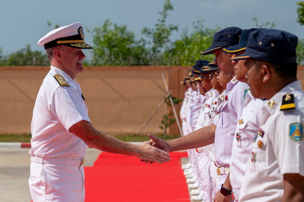 A man shakes hands with another.