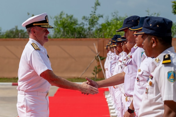 A man shakes hands with another.