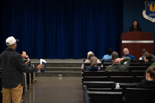 A Hunt Housing resident stands up to ask a question during a town hall meeting on Maxwell Air Force Base, Alabama, Jan. 21, 2026.