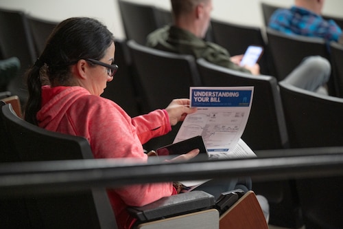 A Hunt Housing resident reviews her flyer during a town hall meeting on Maxwell Air Force Base, Alabama, Jan. 21, 2026.