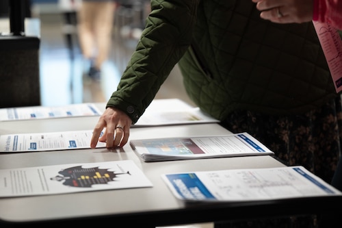 Hunt Housing residents pick up flyers during a town hall meeting on Maxwell Air Force Base, Alabama, Jan. 21, 2026.