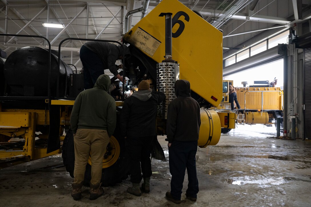 Photo of Andrews Airmen conducting snow removal operations