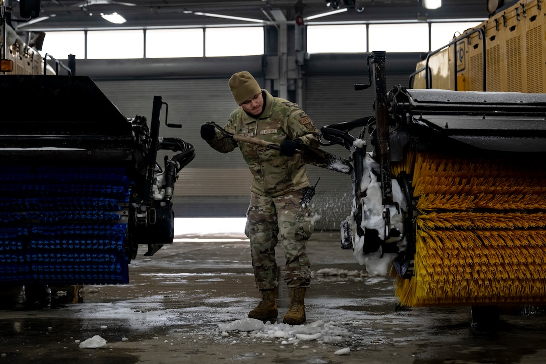 Photo of Andrews Airmen conducting snow removal operations