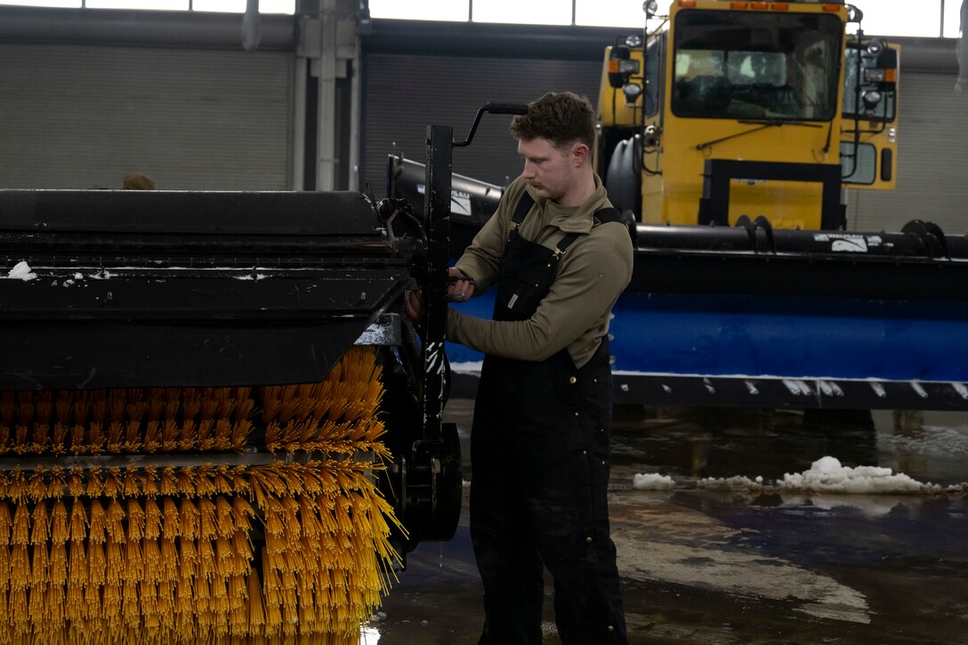 Photo of Andrews Airmen conducting snow removal operations