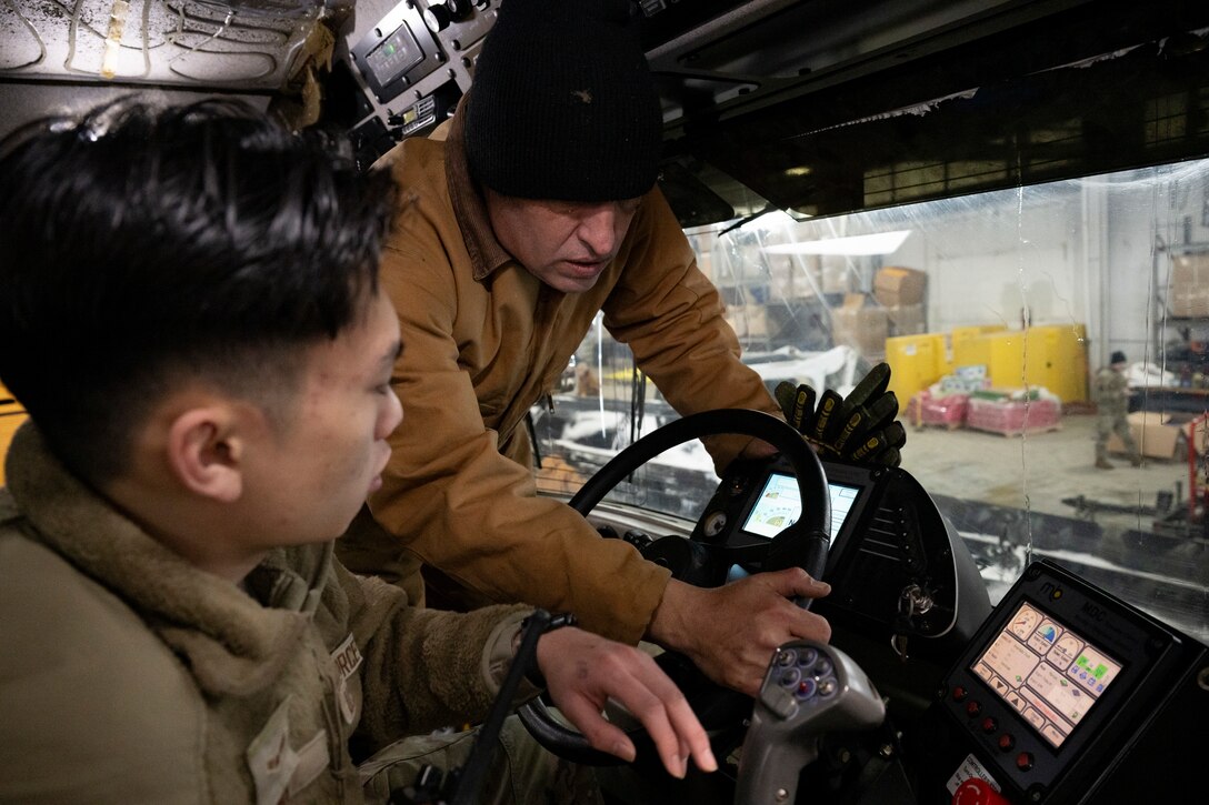 Photo of Andrews Airmen conducting snow removal operations