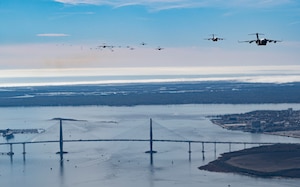A formation of C-17 Globemaster III's trail off into the sky over Charleston