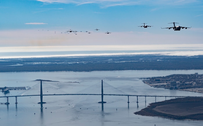 A formation of C-17 Globemaster III's trail off into the sky over Charleston