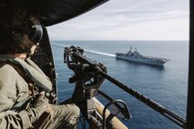 U.S. Marine Corps Cpl. Logan Goetz, a UH-1Y Venom crew chief assigned to Marine Medium Tiltrotor Squadron (VMM) 163 (Reinforced), 11th Marine Expeditionary Unit, prepares to land on the flight deck of Wasp-class amphibious assault ship USS Boxer (LHD 4) in the Pacific Ocean, Jan. 25, 2026.