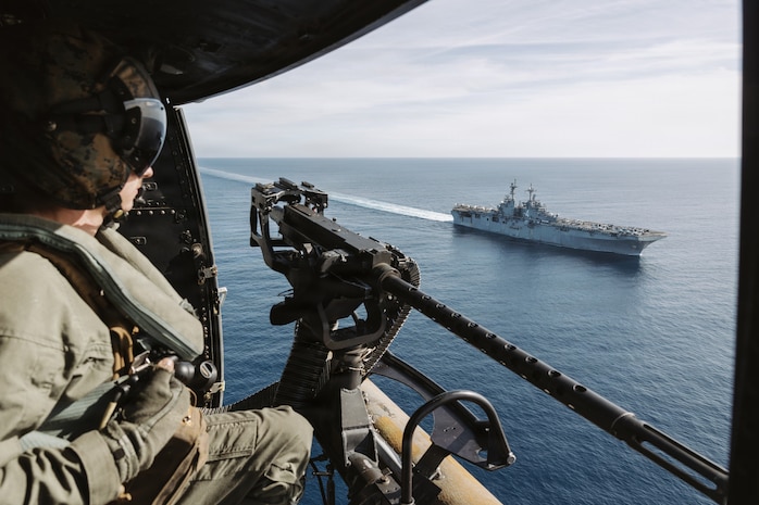 U.S. Marine Corps Cpl. Logan Goetz, a UH-1Y Venom crew chief assigned to Marine Medium Tiltrotor Squadron (VMM) 163 (Reinforced), 11th Marine Expeditionary Unit, prepares to land on the flight deck of Wasp-class amphibious assault ship USS Boxer (LHD 4) in the Pacific Ocean, Jan. 25, 2026.