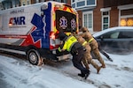 Maryland Army National Guard Soldiers from 1st Battalion, 175th Infantry Battalion and paramedics from Old Town Fire Station push an ambulance out of the snow in Baltimore, Jan. 25, 2026. At the direction of Maryland Gov. Wes Moore, about 160 personnel of the Maryland National Guard activated to support civil authorities with specialized vehicles across the state to ensure rapid response capabilities for communities that may require assistance during inclement weather conditions. Photo by Staff Sgt. Lindiwe Henry.